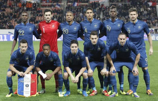 GROUP E - In this Oct. 11, 2013 file photo, France soccer team poses poses prior to the start their international soccer friendly match between France and Australia. Background from left: Eric Abidal, Hugo Lloris, Loic Remy, Raphael Varane, Paul Pogba and Olivier Giroud. Foreground from left: Yohan Cabaye, Patrice Evra, Samir Nasri, Mathieu Debuchy and Franck Ribery. 