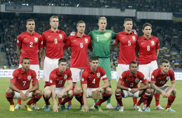 GROUP D - In this Sept. 10, 2013 file photo, England national soccer team poses prior to the World Cup qualifier group H soccer match between Ukraine and England. Background from left: Kyle Walker, Rickie Lambert, Phil Jagielka, Joe Hart, Gary Cahill and Frank Lampard. Foreground from left: Theo Walcott, James Milner, Steven Gerrard, Ashley Cole and Jack Wilshere.