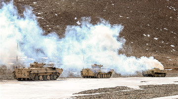 Armored vehicles in maneuver training exercise